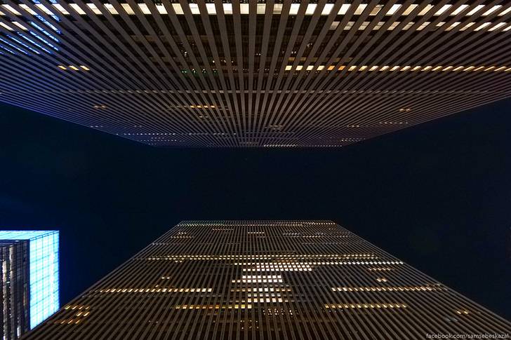 A photo of two Manhattan buildings at night